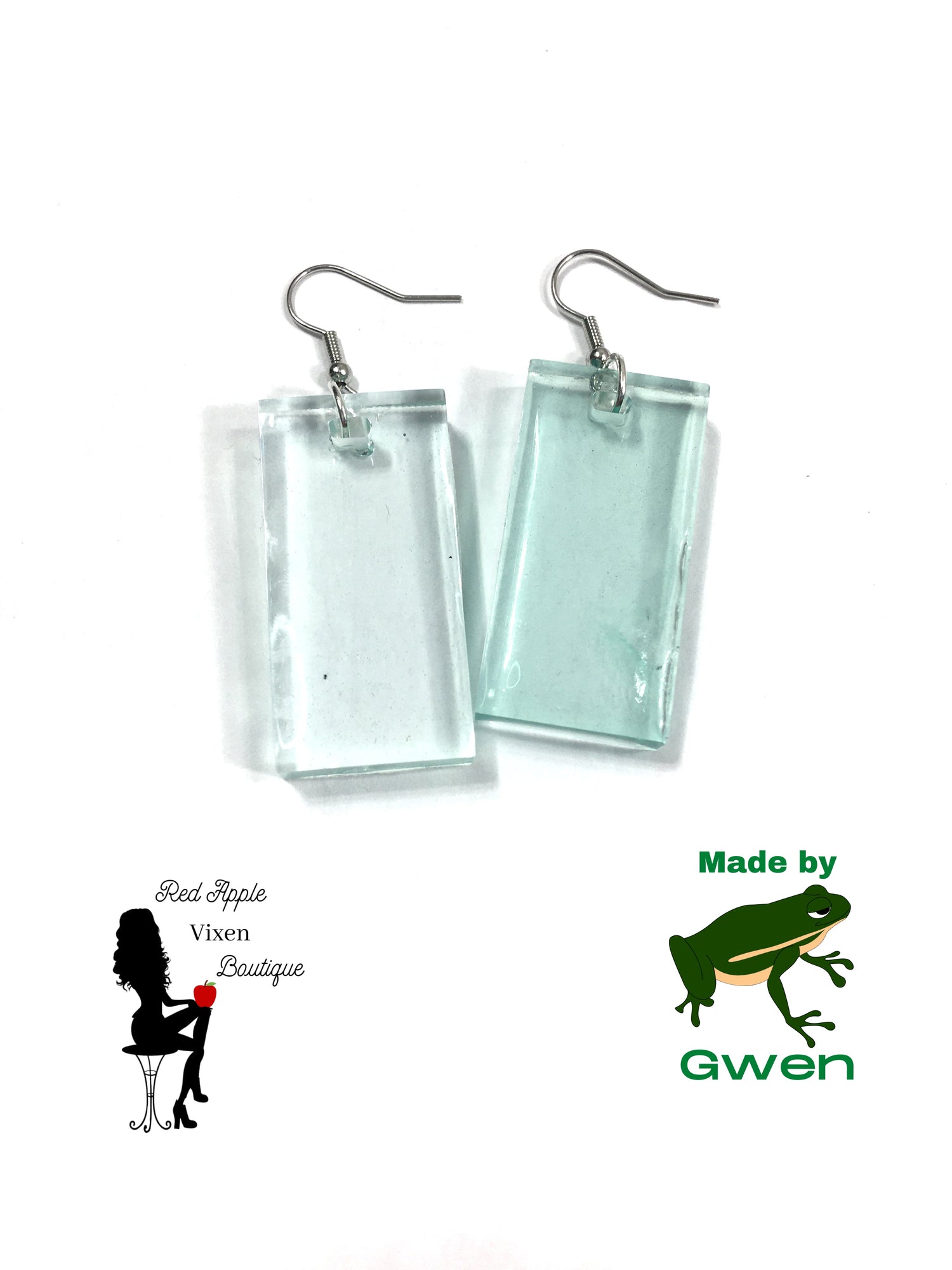 Light Blue Transparent rectangle shaped earrings. Made from Resin. Silver colored fish hook fasteners. Measures approximately 1.5 inches long and 1 inch wide.